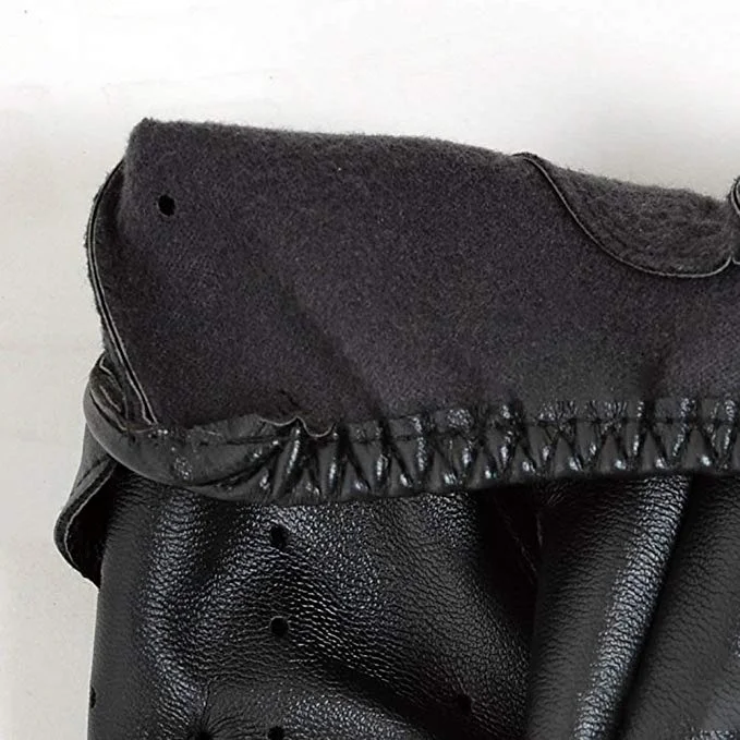 Close-up of the durable edge stitching and knit-style craftsmanship on black leather gloves.