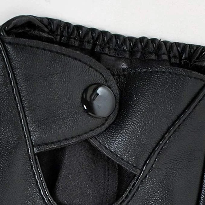 Close-up of the metal snap button fastener on the wrist of a black leather driving glove.